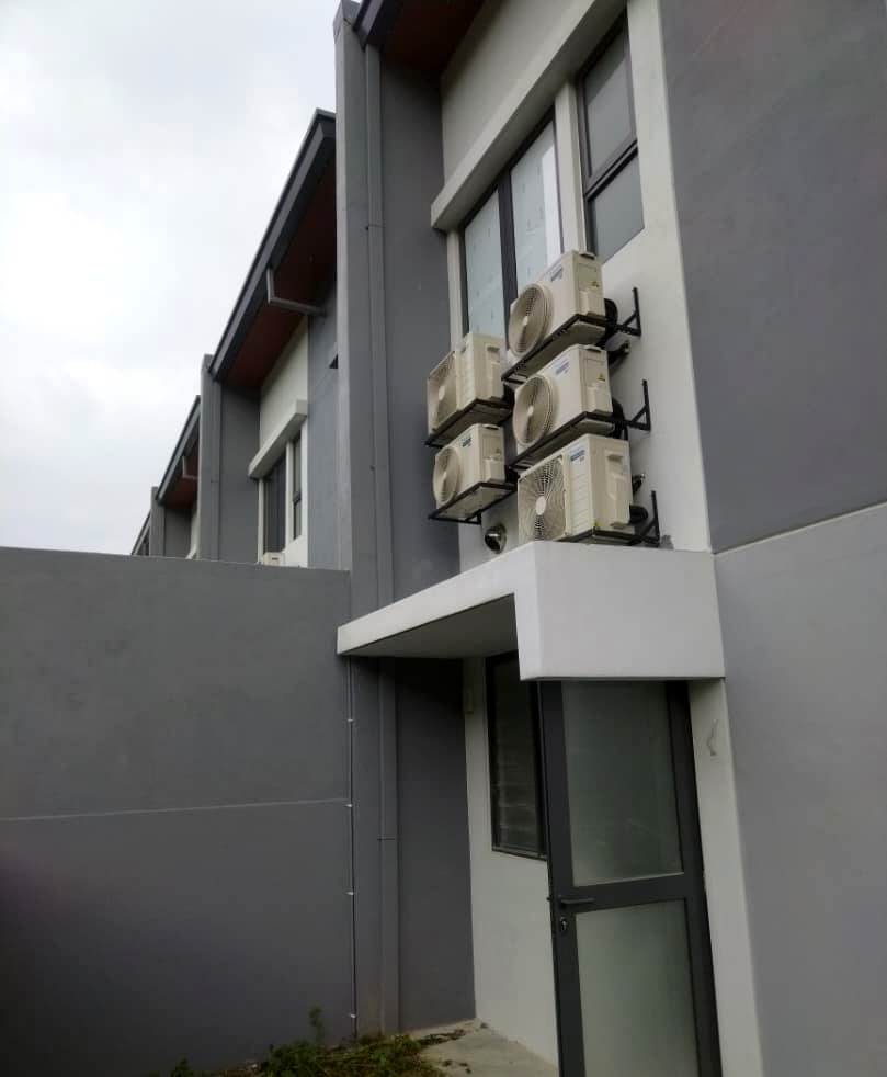 Stacked Daikin outdoor condenser units mounted on exterior wall